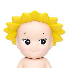 a baby doll with yellow flowers on it's head and eyes, sitting in front of a white background