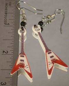 "Lightweight Dangle Earrings featuring print art of a red electric guitar. Handmade Altered art Made with acrylic, resin, stainless steel connectors and surgical steel ear wire. Highlighted with glass beads. Measure 2 3/4\" long. Pay one low shipping price for all items ordered. US orders ship for $3.50 Visit www.afanaffair.com or the 'Wearable Memories' shop section on Etsy to find out how to put your own photos on jewelry Like us on facebook for money saving coupons and offers" Guitar Earrings, Guitar Jewelry, Red Electric Guitar, Red Rocker, Guitarist Gifts, Cool Earrings, Weird Jewelry, Rocker Girl, Girl Accessories