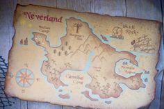 a map on the side of a wooden wall that says neverland and features several locations