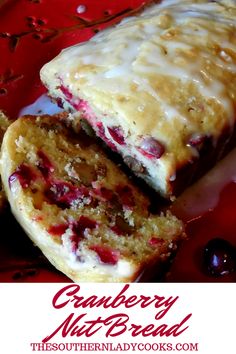 cranberry nut bread is cut in half on a red plate with white icing