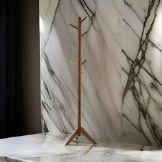 a marbled room with a coat rack in the corner