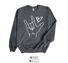 a grey sweatshirt with the word love written on it and two fingers up in the air