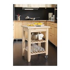 a kitchen island cart with food on it