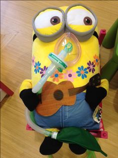 To prepare patients in having general anesthesia by using medical play preparation on Dave. The Child Life Specialist is showing a patient the anesthesia mask Dave is wearing before having surgery. Child Life Specialist Activities, Anesthesia Mask, Minion Doll, General Anesthesia, Life Tools, Kid Character