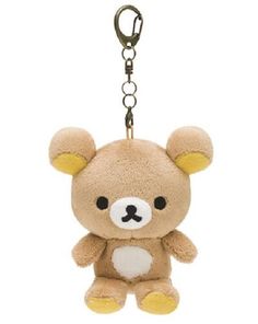 a brown teddy bear keychain hanging from a metal hook