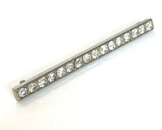 a white gold diamond bar brooch or pin with four rows of diamonds on each side