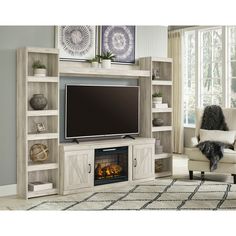 a living room with a fireplace and entertainment center