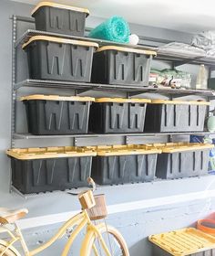 there is a bike and some bins on the wall in this garage storage area