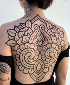 a woman with tattoos on her back