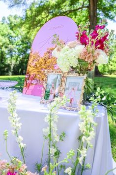 a table with flowers and pictures on it