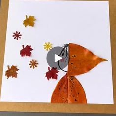 a card with an image of a fox surrounded by autumn leaves and paper cut outs