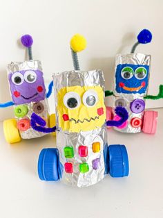 three paper bag crafts made to look like robots