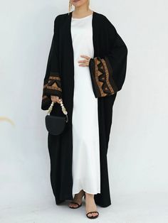 Step into elegance with the ‘Anwara' Open Abaya, adorned with intricately embroidered sleeves that add a unique flair to this classic piece. Made from premium polyester, this abaya is both lightweight and durable, ensuring long-lasting wear. The open-front design allows for versatility in styling, making it easy to pair with different outfits. Whether you're dressing up for an event or keeping it casual, the 'Anwara' abaya is sure to make a statement with its delicate detailing and comfortable f Elegant Long Sleeve Abaya With Embroidered Border, Long Embroidered Abaya For Eid, Long Abaya For Eid, Traditional Long Sleeve Abaya With Embroidered Border, Traditional Long Sleeve Embroidered Abaya, Black Long Sleeve Agbada For Eid, Long Sleeve Black Agbada For Eid, Long Abaya With Dabka Work, Long Sleeve Dabka Abaya