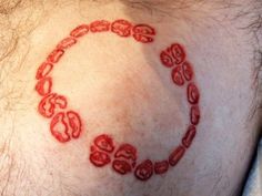 a close up of a man's chest with red ink on his chest and the word love written in it