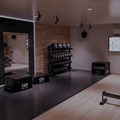 an empty gym with dumbs and exercise equipment