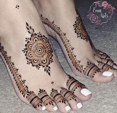 the feet are decorated with henna designs