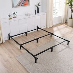 a bed frame sitting on top of a wooden floor