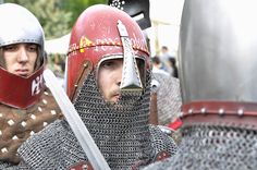 two men dressed in medieval armor and helmets