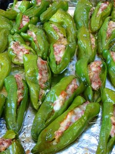 green peppers with meat on them sitting on tin foil covered in sauce and seasoning