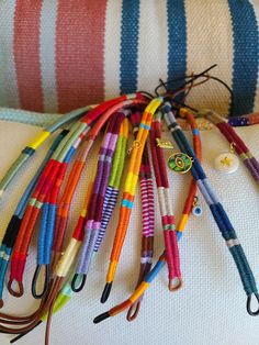 many different colored crochet hooks on a pillow