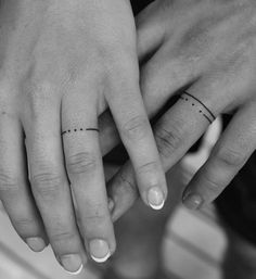 two people with wedding rings on their fingers