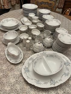 a table topped with lots of plates and cups