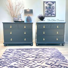 two blue dressers sitting next to each other on top of a white rug in front of a wall