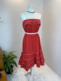 1980s dress / 80s dress / vintage sun dress This is such a cute 1980's, possibly late 1970's dress. She is made from a red and white polka dot cotton with white trim. She has a Double ruffle bodice and a three tiered skirt. For absolute comfort she has an elastic waistband and bodice line. She has two white spaghetti straps and is so adorable. Measurements provided are flat and have been doubled. Bust 34/35" range due to elastic Waist 26-30" suggested range for elastic Hips 40"   Length 41" ❤️ Condition: Excellent vintage condition. Flaw: none found. Belt in photos not included.This item has been cleaned and is ready to wear. $126 includes domestic shipping and insurance. International shipping is $30. Please let me know if you have questions, would like more measurements, or photos. I am Vintage Ruffled Midi Dress For Summer, Spring Polka Dot Cotton Midi Dress, Spring Cotton Midi Dress In Polka Dot, Vintage Polka Dot Lined Dresses, Summer Cotton Polka Dot Midi Dress, Cotton Polka Dot Midi Dress For Summer, Retro Summer Dresses Lined, Retro Vintage Midi Dress With Ruffles, Retro Lined Summer Dresses