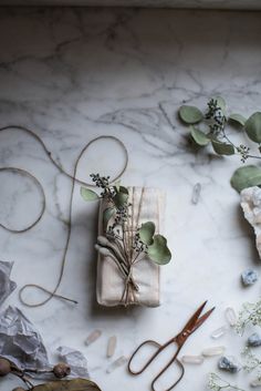 flowers, scissors and other items laid out on a marble surface