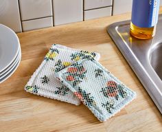 two napkins sitting on top of a kitchen counter