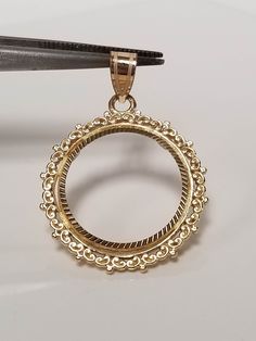 "Thanks for shopping our vintage estate store. We tend to sell well below wholesale and truly hope you enjoy all of our items. Many of the items are one of a kind, so please enjoy scrolling through the pictures and hopefully something will catch your eye. Spots are from reflection or camera. Estate 14k yellow gold bezel holder 1/10-coin rope twist pendant. Works great with any 1/10 gold coins. Length: 1 1/8\" Diam: 3/4\" Weight: 2.34 grams Bail: 3mm Nice 14k coin bezel pendant." Luxury Jewelry With Filigree And Round Pendant, Classic Intricate 14k Gold Jewelry, Luxury Filigree Jewelry With Round Pendant, Luxury Round Pendant Jewelry With Filigree, Collectible Yellow Gold Filigree Necklaces, Classic Filigree Round Pendant Jewelry, Ornate 14k Stamped Jewelry For Formal Occasions, Classic Necklaces With Intricate Round Pendant, Classic Necklace With Intricate Round Pendant