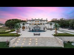 an aerial view of a mansion with steps leading up to the front door and pool