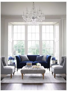 a living room filled with furniture and a chandelier