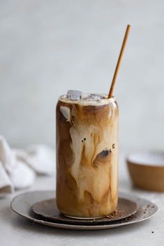 an iced drink on a plate with a wooden stick sticking out of it's top