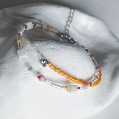 This handcrafted bracelet features a vibrant combination of orange, white, and purple beads, designed to create a cheerful and unique accessory. The playful colors bring a lively touch to any outfit, making it perfect for both casual and festive occasions. Ideal for gifting or treating yourself to a special, one-of-a-kind piece. Adjustable length High-quality glass beads Handmade with love and care ✴︎Each design is created in extremely limited quantities, with only 1 or 2 pieces made per style. This exclusivity ensures that you are purchasing a truly unique piece of jewelry that stands out. Orange Bracelets With Colorful Beads For Jewelry Making, Trendy White Bracelets With Beaded Chain, Trendy White Beaded Chain Bracelets, Orange Beaded Bracelets For Jewelry Making, Adjustable Orange Beaded Chain Bracelets, Handmade Orange Bracelets With Round Beads, Orange Bracelet With Spacer Beads As Gift, White Beaded Chain Friendship Bracelets As Gifts, White Beaded Chain Friendship Bracelet As Gift