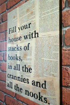 an old book is hanging on a brick wall with the words fill your house with stacks of books in all the cranies and all the nooks