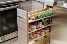 an open cabinet in a kitchen with spices and condiments