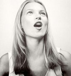 a black and white photo of a woman with her mouth open