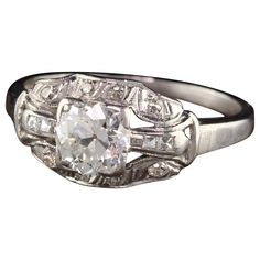 an antique style diamond ring with three stone accents