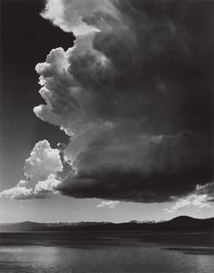 black and white photograph of clouds over water