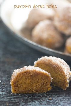 there are two pieces of pumpkin donut holes on the table