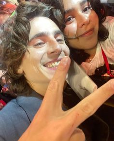 two people with painted faces posing for the camera