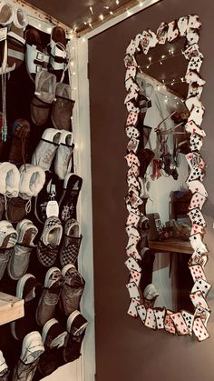 a room filled with lots of hats and other items on the wall next to a mirror