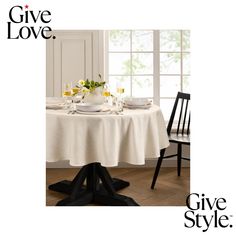 a table with plates and cups on it in front of a window that says give love