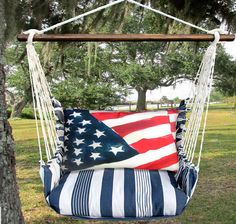 a hanging chair with an american flag pillow