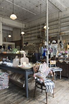 a room filled with furniture and lots of clutter on top of wooden flooring