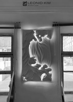 a black and white photo of a wall sculpture