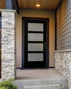 a black front door on a house with stone steps