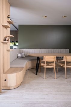 a circular table and benches in a room