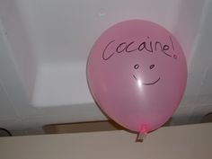 a pink balloon with a face drawn on it and the words'caane'written in cursive writing